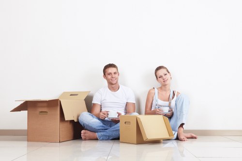 Professional removals team handling boxes and furniture in a flat move
