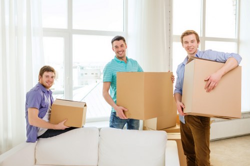 Staff using careful lifting techniques during a removals job