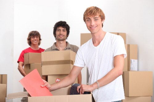 Careful loading of unwanted furniture into a collection vehicle